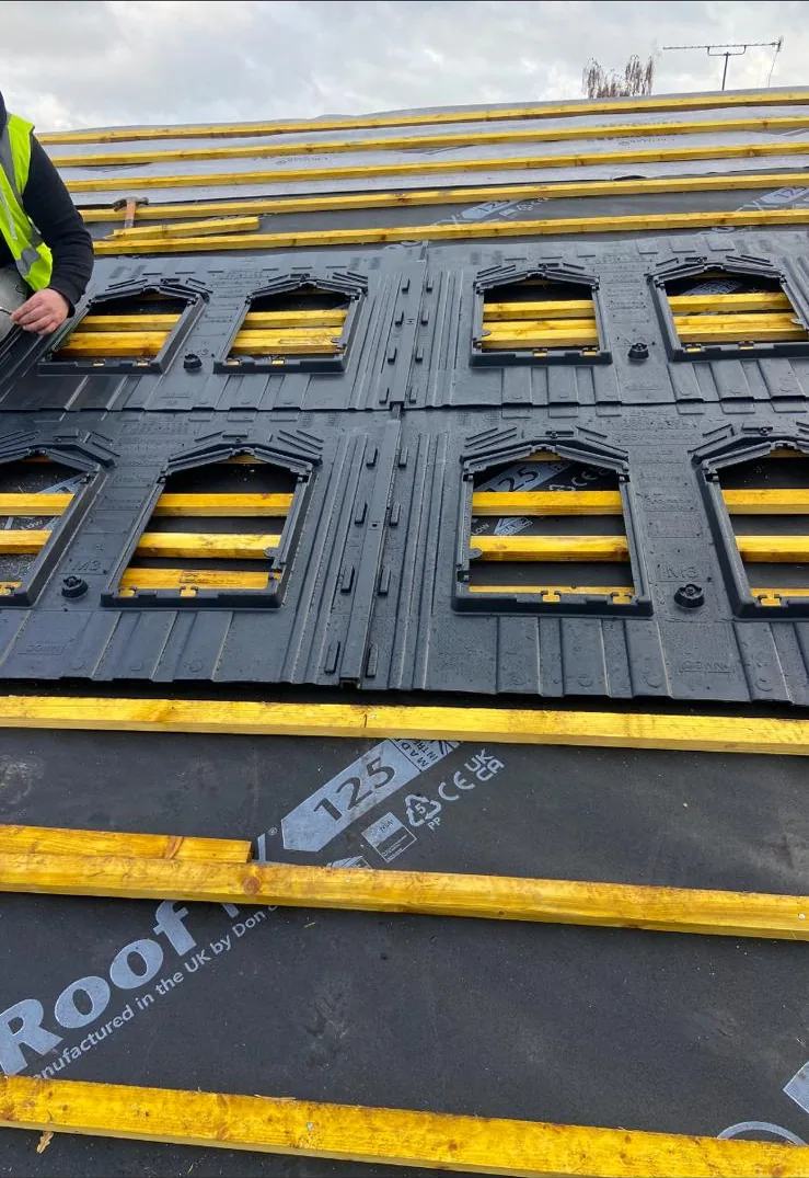 Black in-roof solar mounting trays fixed over new roof membrane and battens