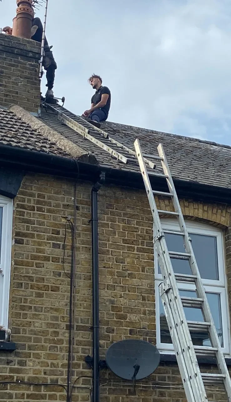 The Sherwood Roofing team working on the roof of a brick terrace in Kent